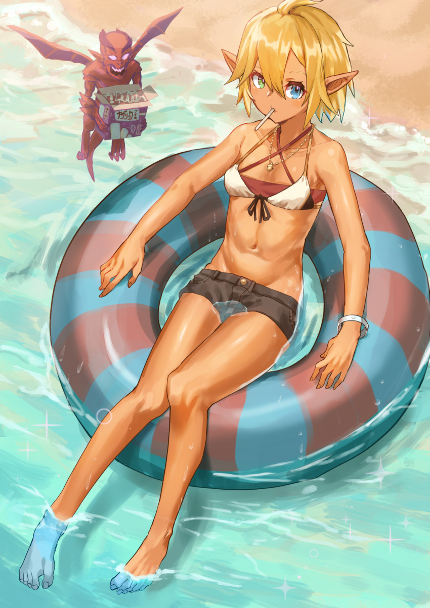 aura_bella_fiora bare_shoulders barefoot beach black_shorts blonde_hair blue_eyes candy dark_elf day elf female food food_in_mouth full_body green_eyes heterochromia highres jewelry lollipop looking_at_viewer midriff mouth_hold navel necklace outdoors overlord_(maruyama) pointy_ears shiny_skin short_hair shorts solo swimsuit tsugu0302