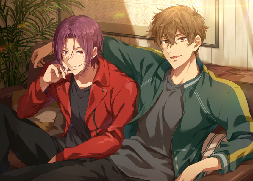 2boys arm_around_shoulder between_legs black_pants black_shirt brown_hair collarbone collared_jacket commentary couch free! green_jacket grin hair_between_eyes hand_between_legs hand_on_own_cheek hand_on_own_face head_rest indoors jacket kirishima_natsuya knee_up looking_at_viewer male_focus matsuoka_rin multiple_boys on_couch open_mouth painting_(object) palm_tree pants picture_frame plant potted_plant red_eyes red_hair red_jacket sharp_teeth shirt side-by-side sitting smile striped_pillow teeth track_jacket tree wooden_wall zattape