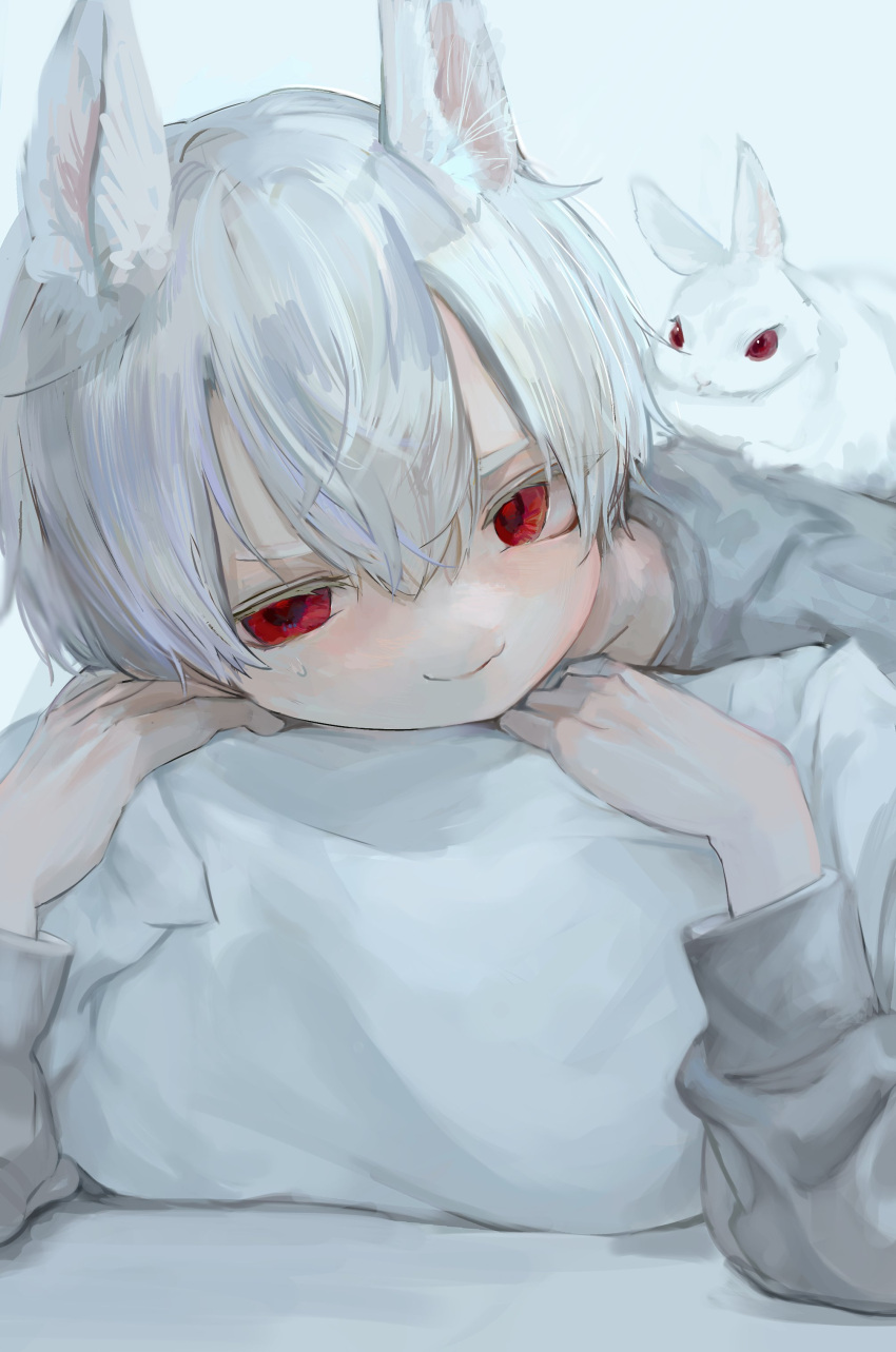 1boy absurdres animal animal_ears animal_on_back bad_id bad_twitter_id closed_mouth commentary hair_between_eyes highres hzk_(user_kemd2843) long_sleeves looking_at_viewer lying male_focus on_stomach original pillow pillow_grab rabbit_boy red_eyes shirt short_hair smile white_background white_hair