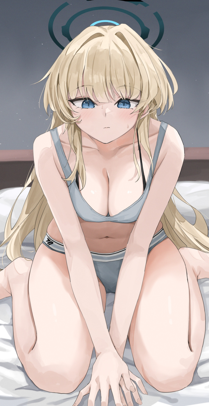 absurdres bare_arms bare_legs blonde_hair blue_archive blue_eyes blush breasts cleavage closed_mouth collarbone commentary_request female grey_sports_bra halo highres jeon_(user_ywaw3774) large_breasts long_hair looking_at_viewer navel on_bed sitting solo sports_bra stomach toki_(blue_archive) wariza