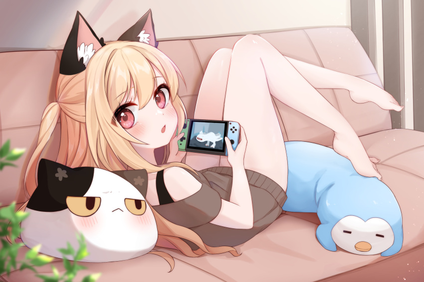 absurdres animal_ear_fluff animal_ears atsuki_(pink0930cat) bare_arms bare_legs barefoot blonde_hair blush cat_ears chestnut_mouth controller couch female half_updo highres holding holding_controller khezu knees_up legs_up long_hair looking_at_viewer looking_back lying monster_hunter_(series) nintendo_switch off-shoulder_sweater off_shoulder on_back on_couch open_mouth original pink_eyes short_sleeves solo stuffed_animal stuffed_cat stuffed_penguin stuffed_toy sweater video_game