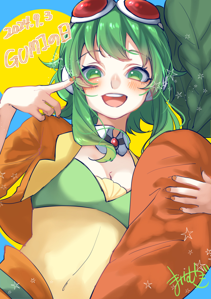 blush breasts brooch cleavage dated female goggles goggles_on_head green_eyes green_hair gumi highres jacket jewelry looking_at_viewer mai_mugi medium_breasts open_clothes open_jacket open_mouth orange_jacket orange_nails short_hair_with_long_locks simple_background solo stuffed_carrot upper_body vocaloid