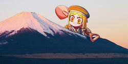  blonde_hair coat collared_jacket commentary_request fate/grand_order fate_(series) female giant giantess gloves green_coat green_headwear green_jacket highres jacket mount_fuji mountain official_art paul_bunyan_(fate) photo_(medium) riyo_(lyomsnpmp) shovel solo yellow_eyes 