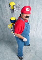  1boy black_hair cosplay f.l.u.d.d. facial_hair fludd gloves hat male male_focus mario mario_(cosplay) mario_(series) moustache nintendo overalls photo shoes short socks solo super_mario_bros. suspenders white_gloves 