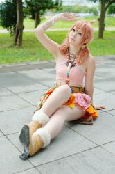  belt boots bracelet cosplay female female final_fantasy final_fantasy_xiii grass jewelry midriff necklace oerba_dia_vanille oerba_dia_vanille_(cosplay) on_floor outdoors pink_shirt shirt sitting skirt solo tile tiles tree twintails 